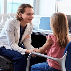 Thearpist taking in person session of a child